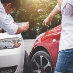 Two drivers man arguing after a car traffic accident collision and making phone call to Insurance Agent and take a photo, Traffic Accident and insurance concept