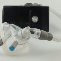 CPAP machine with adult full face mask for the treatment of sleep apnoea, isolated on a white background