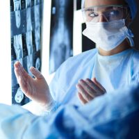 Two female women medical doctors looking at x-rays in a hospital. Two female women medical doctors looking at x-rays in a hospital.